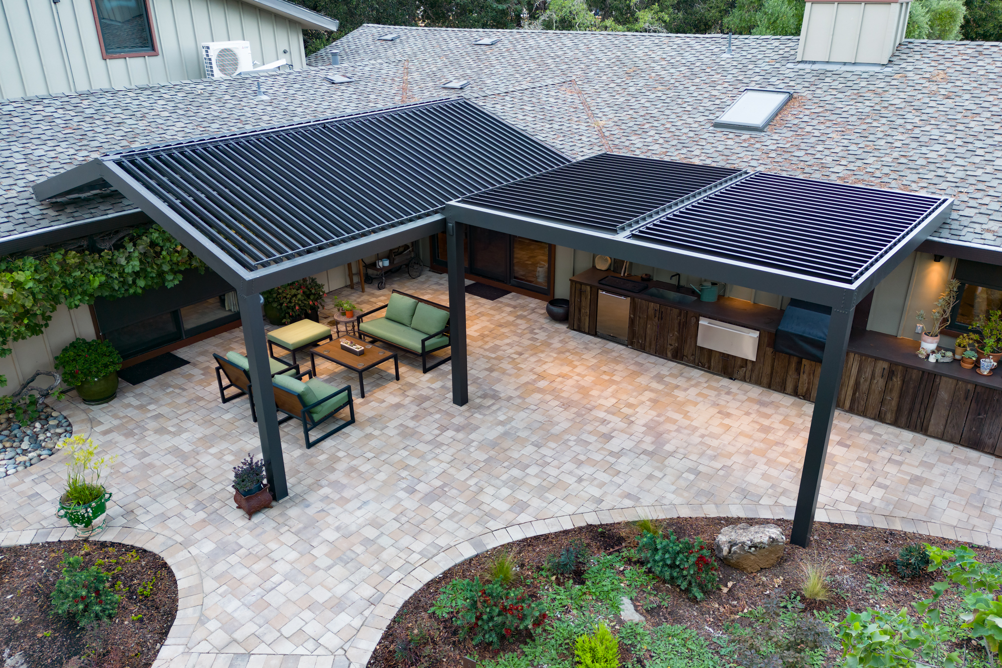 Aerial view of a charcoal pergola system covering an outdoor kitchen and patio.